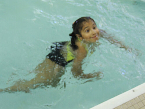 Camper swimming in the pool at the Webster Aquatics Center
