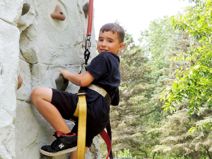 Camper climbing rock wall