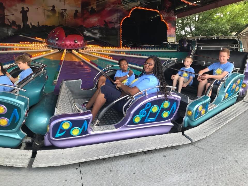 Campers enjoying a merry-go-round.