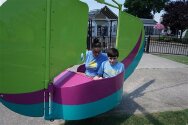Young campers enjoying a carnival ride.