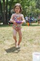 Camper carrying wet sponge for water games