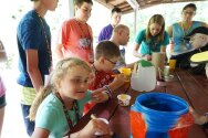 Campers painting containers for a totem pole craft