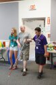 Counselors guiding a camper through our camp building