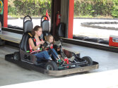 Two campers sitting in a go-kart.