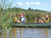 Camper kayaking in a green kayak.