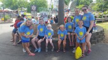 Lots of campers in blue shirts gathered for a photo.