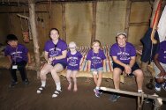 Campers & counselors sitting in a long house at Gonondagan