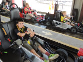 Campers sitting in go-karts ready to race.
