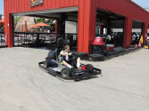 Young camper racing in a go-kart.