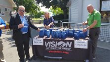 Vision Automotive Group setting up a table.