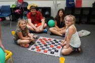 Campers and counselors playing checkers