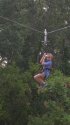 Young camper ziplining down.