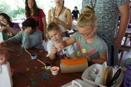 Campers painting containers for a totem pole craft