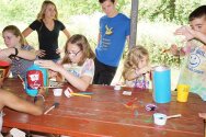 Campers painting containers for a totem pole craft