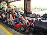 Two campers sitting in a go-kart.