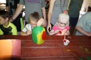 Campers decorating their totem pole pieces