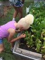 A young camper smelling fresh plants.
