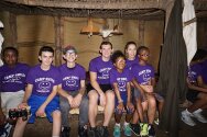 Counselors & campers sitting in a long house at Gonondagan